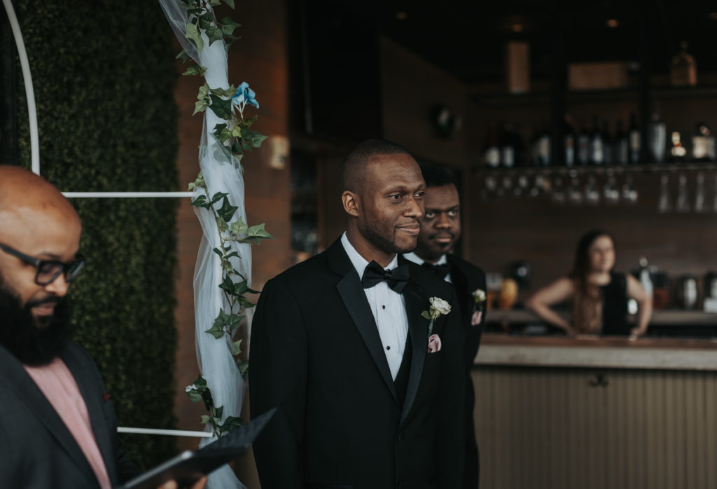Groom sees bride as she walks down the aisle at their micro wedding in Memphis, TN