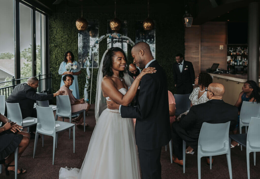 A bride and groom share their first dance in an intimate ceremony at Terrace at The River Inn.
