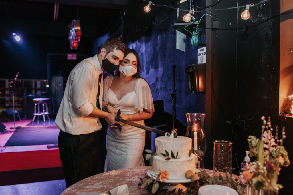 a newlywed couple cuts their cake at the HiTone in Memphis, TN