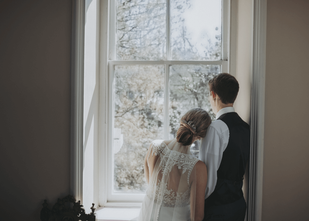 Newlyweds stand together and look out of the tower window of the Woodruff Fontaine House in Memphis.