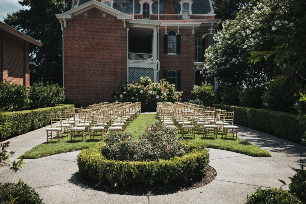 Ceremony set up with chairs outside the mansion on the lawn.