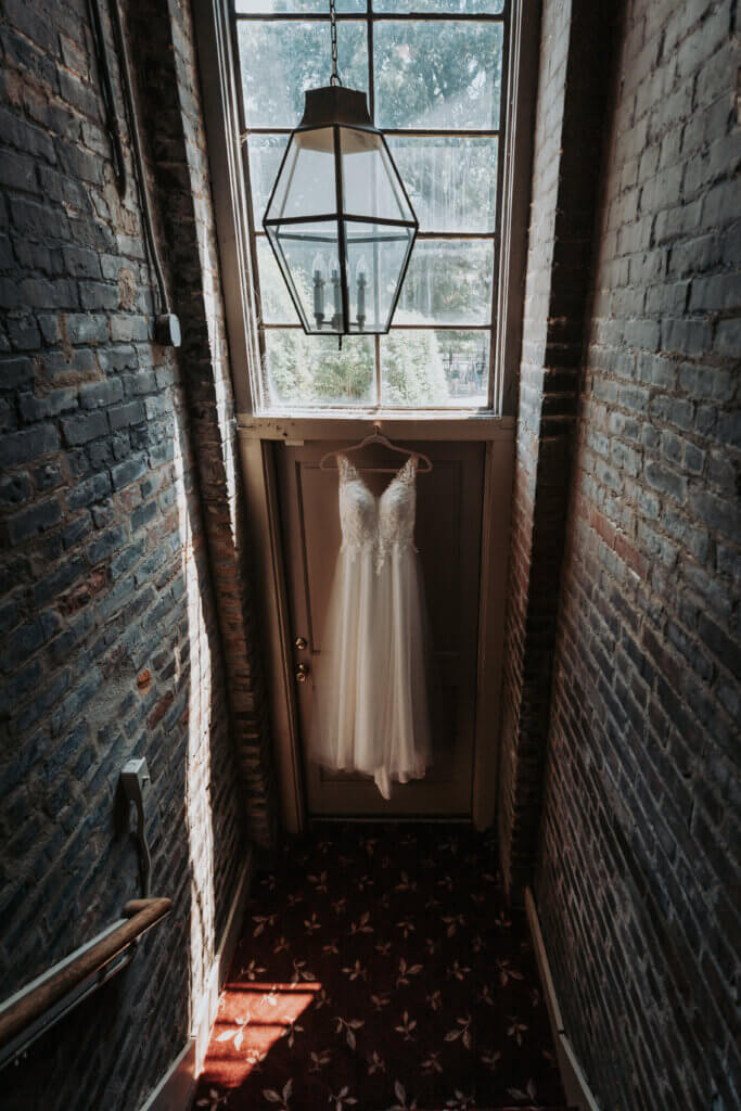 wedding dress hanging in the hall of the Woodruff Fontaine House Museum in Memphis, TN, shot by Wandering Creative