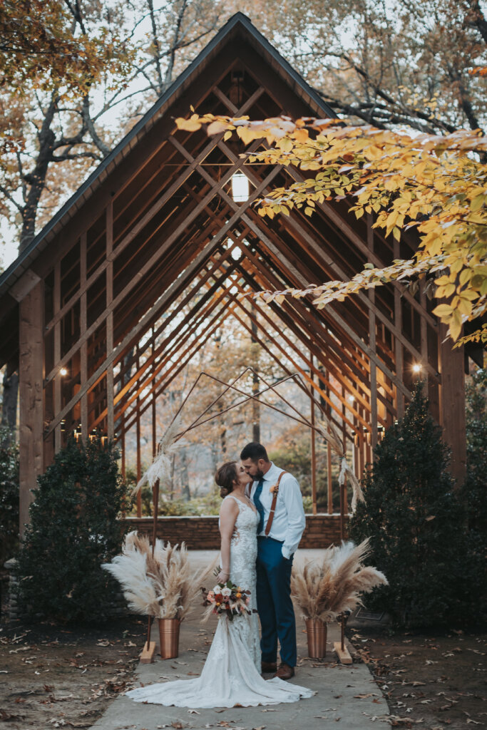 bride and groom kiss at the pavilion at memphis botanic gardens