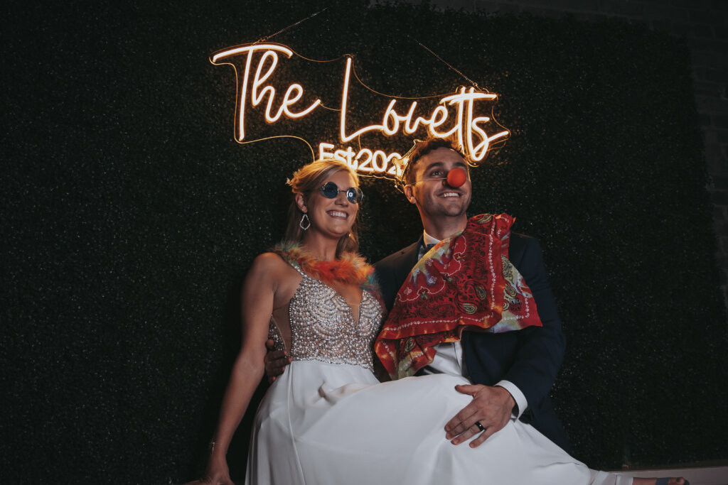 Newlywed couple poses in a photo booth at their wedding reception in Memphis.