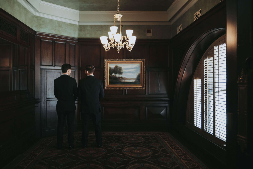 Groom stands in the Oak Room waiting for his new bride to arrive for their first look.