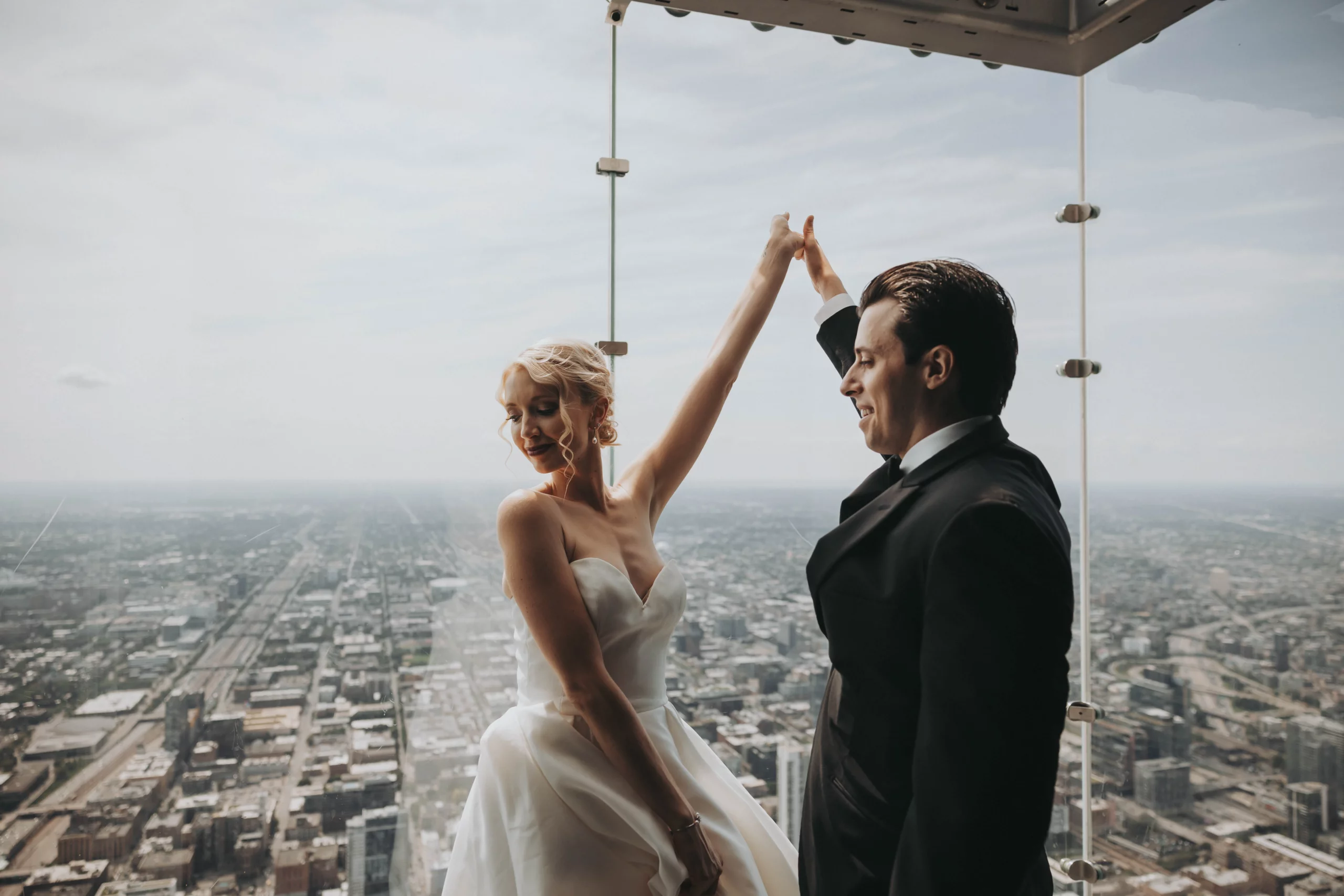 Newlyweds stand together on the Skydeck at the Willis Tower in Chicago